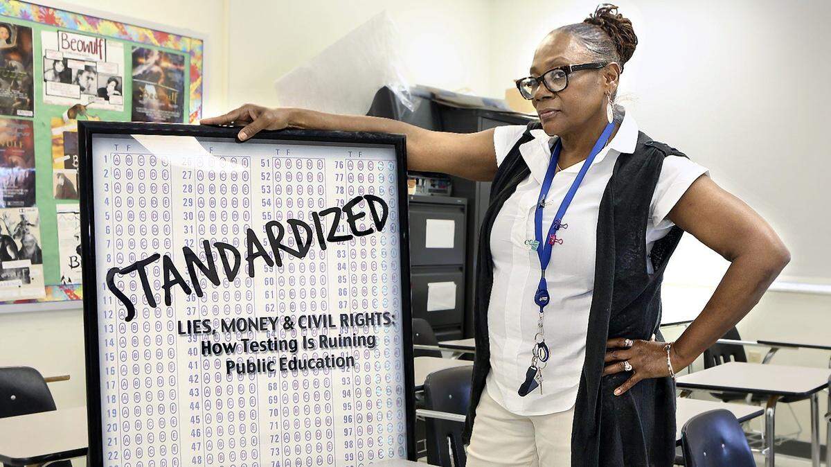 
Ceresta Smith poses with a movie bill for “Standardized,” a 2013 documentary about the adverse effects of standardized testing, on Thursday, April 21, 2016 in her language arts classroom at John A. Ferguson Senior High School. Smith teaches English IV to seniors; she keeps the poster on a wall near her desk; Smith is a co-founder and administrator of United Opt Out National, described on its website as “the movement to end corporate education reform.” She says the movement to have students opt out of state standardized testing has yet to take a huge hold in Miami-Dade, where cultural and language challenges may keep parents from seeking it for their children. John A. Ferguson Senior High School is at 15900 SW 56th St., in Miami’s West Kendall.