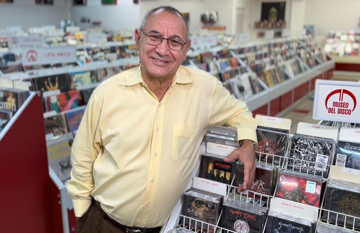 Owner Hinsul Lazo stands by racks of CDs and vinyl recordings in his Museo del Disco in Miami, as he gears up for Record Store Day on April 23, 2022.