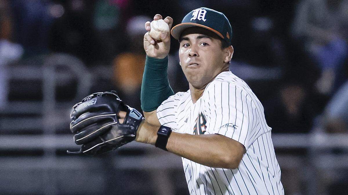 Miami Hurricanes infielder Daniel Cuvet (14) throws to first base during the baseball game against the Lehigh Mountain Hawks for the Hurricanes season opener at Mark Light Field in Coral Gables, Florida, Florida on Friday, February 13, 2026 