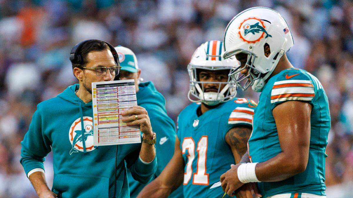 Miami Dolphins head coach Mike McDaniel talks with Dolphins quarterback Tua Tagovailoa (1) during second quarter of an NFL football game against the Dallas Cowboys at Hard Rock Stadium on Sunday, Dec. 24, 2023 in Miami Gardens, Fl.