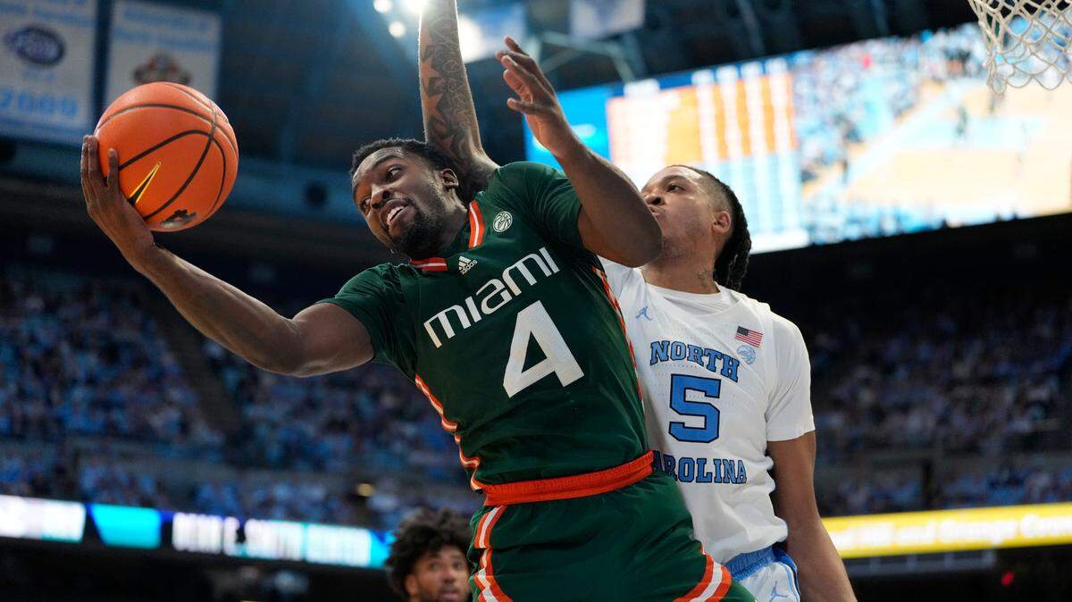 Feb 26, 2024; Chapel Hill, North Carolina, USA; Miami (Fl) Hurricanes guard Bensley Joseph (4) with the ball as North Carolina Tar Heels forward Armando Bacot (5) defends in the second half at Dean E. Smith Center. Mandatory Credit: Bob Donnan-USA TODAY Sports