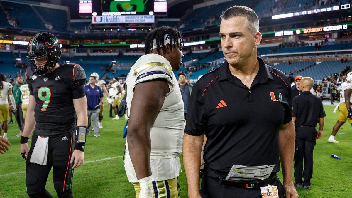 Miami Hurricanes head coach Mario Cristobal and quarterback Tyler Van Dyke (9) walk off the field after Georgia Tech Yellow Jackets defeat the Canes in the final seconds of the game at Hard Rock Stadium in Miami Gardens on Saturday, October 7, 2023.