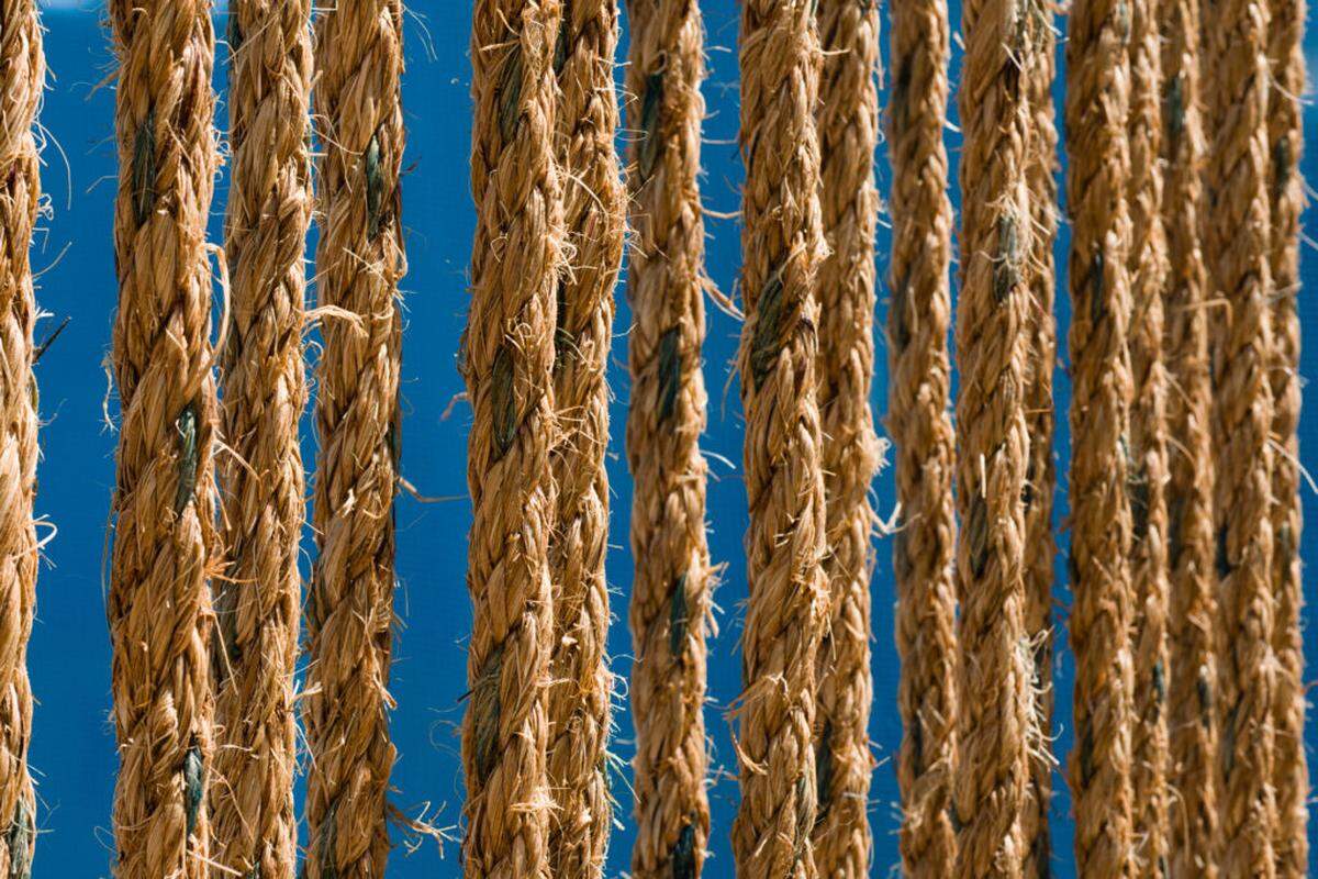 The room-like spaces are bound by woven and hanging ropes and floored with sand in Alexandra Fields O’Neale’s “Bound//Unbound.”