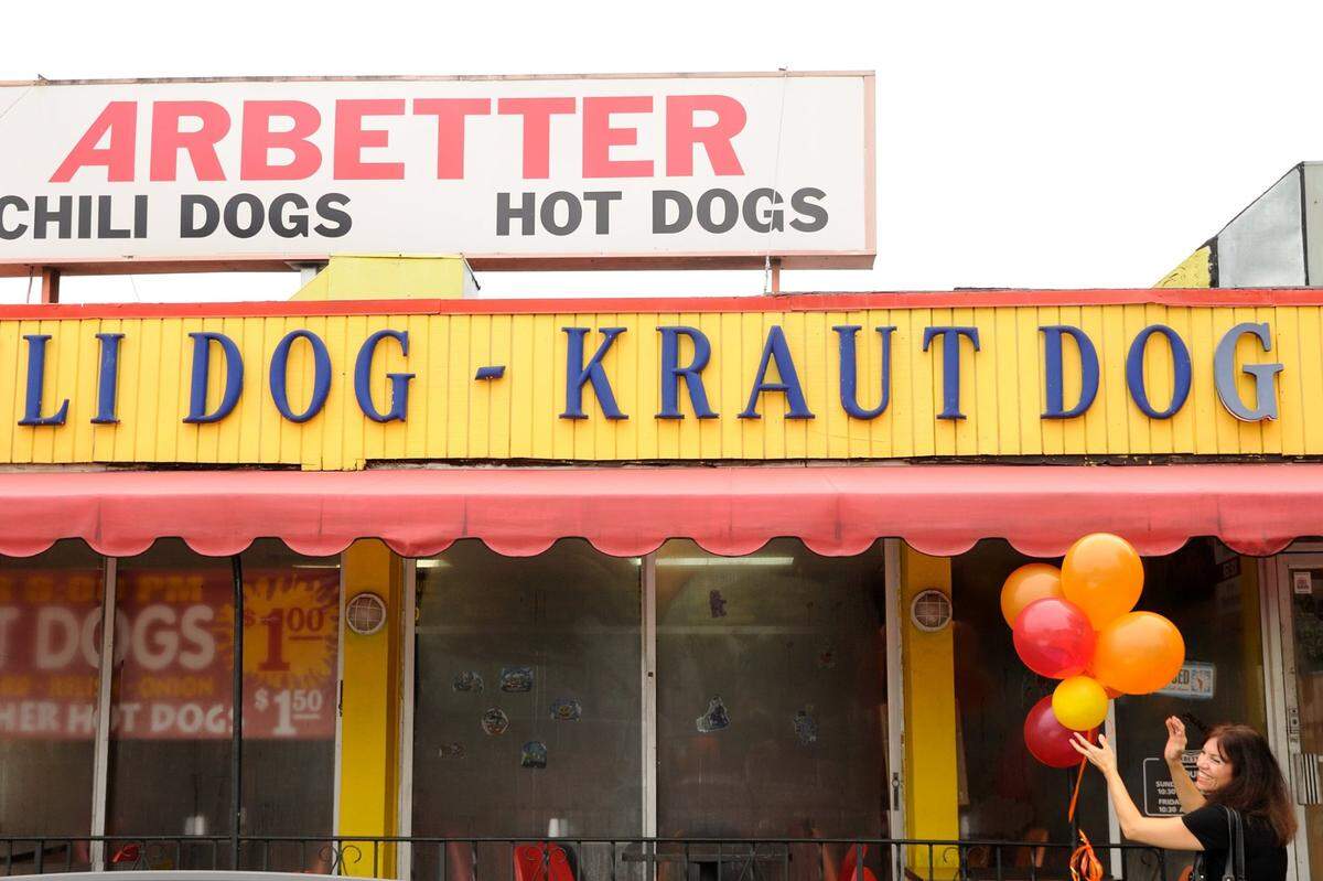 Francesca Lozzi, niece to founder Bob Arbetter, decorates for a street naming party at Arbetter Hot Dogs in Westchester, Thursday, Oct. 14, 2010. The shop has been located at 8747 Bird Road since the early 1970s.