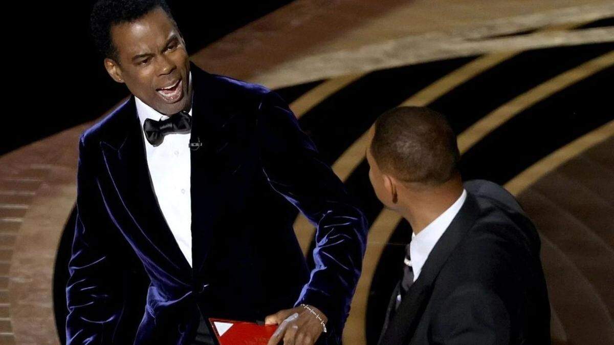 Chris Rock reacts after being smacked by actor Will Smith onstage at the Academy Awards.