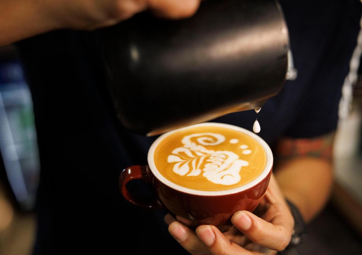 Didier Higuita, a fourth generation coffee grower from Colombia, makes a Sea Horse out of foam, a form of coffee art in a latte, during the morning on Tuesday, Feb. 18, 2025, at Macondo Coffee in Doral, Fla. Higuita started working seasonally at Macondo in 2017 while he was still working in coffee in Colombia and moved here to work full time in 2022.