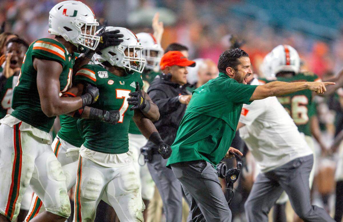 Miami Hurricanes head coach Manny Diaz and the Canes sideline react after a recovered fumble by Jimmy Murphy (29) during their Nov. 9 win against Louisville. Diaz made several changes this year after going 6-7 in his first season as UM’s head coach.
