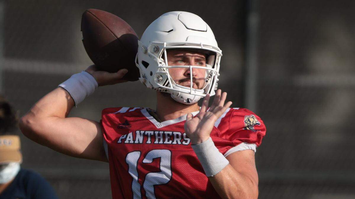 Quarterback Gunnar Holmberg, right, takes the snap and looks cross field during passing drills at practice. On Monday, August 1, 2022 FIU football team opened morning practiced to the media on the practice field on the Tamiami Campus.