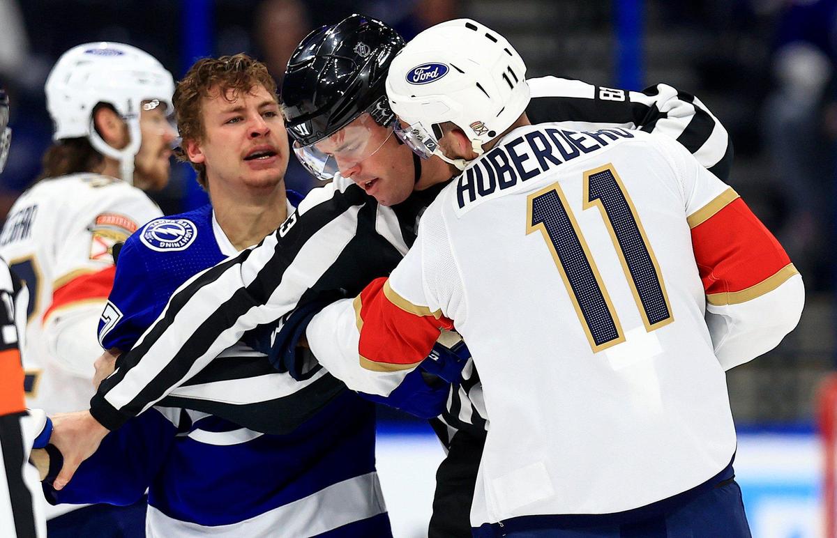 TAMPA, FLORIDA - MAY 22: Yanni Gourde #37 of the Tampa Bay Lightning and Jonathan Huberdeau #11 of the Florida Panthers fight during Game Four of the First Round of the 2021 Stanley Cup Playoffs at Amalie Arena on May 22, 2021 in Tampa, Florida. (Photo by Mike Ehrmann/Getty Images)