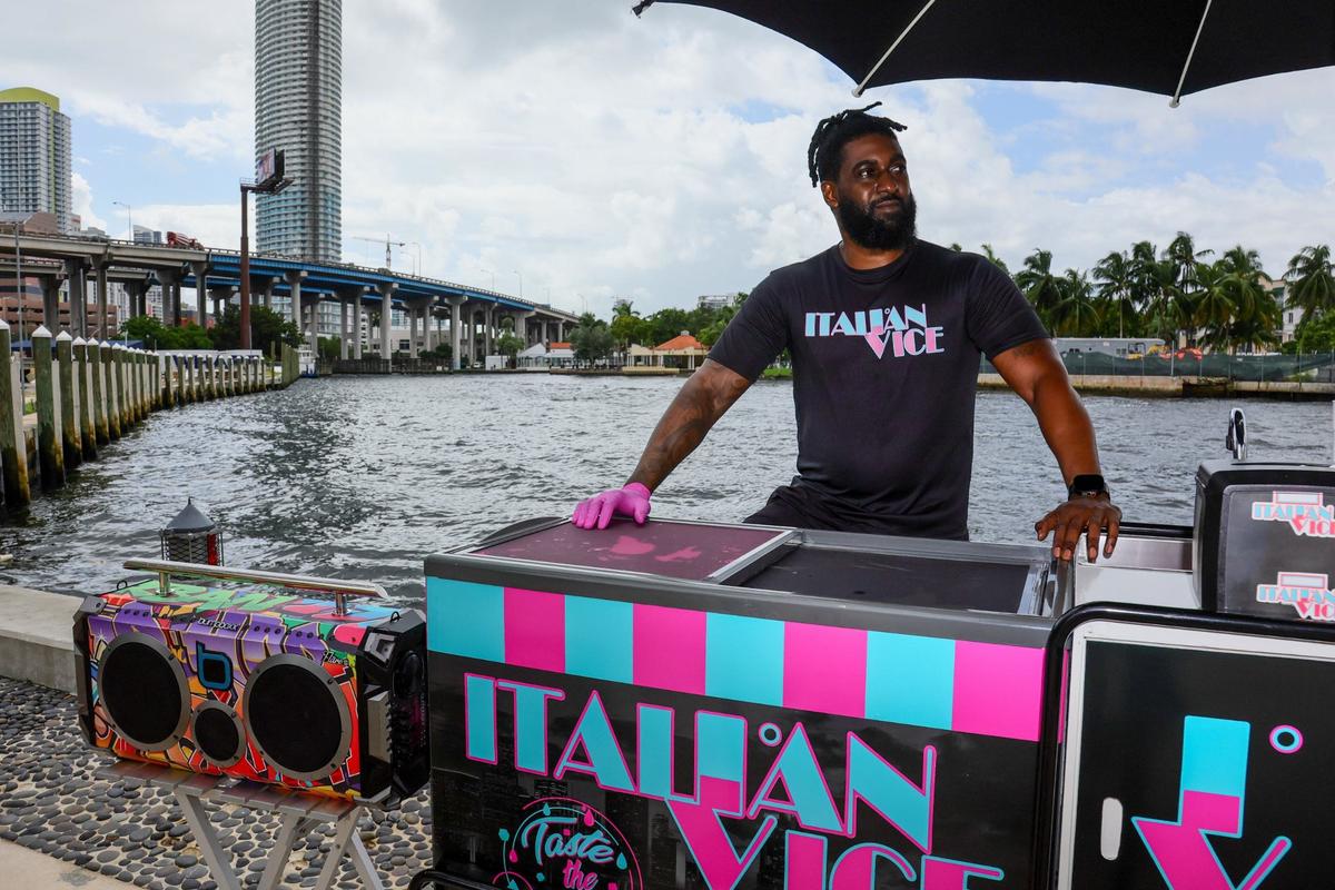 Aamir Taylor, owner of Italian Vice, a Miami-based water ice company, is photographed with his mobile cart by the Miami River in downtown Miami on Friday, Oct. 11, 2024.