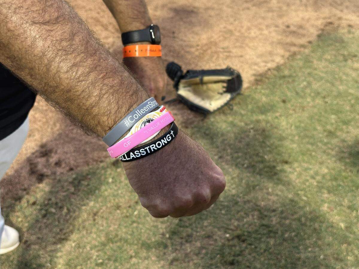 Stoneman Douglas coach Todd Fitz-Gerald shows the wristband he wears in honor of his wife, Colleen, who is battling brain cancer.