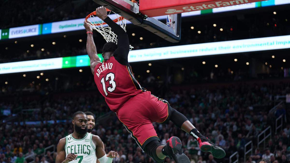 Miami Heat center Bam Adebayo (13) dunks over Boston Celtics guard Jaylen Brown (7) during the second half of game two of the Eastern Conference Finals for the 2023 NBA playoffs at TD Garden.