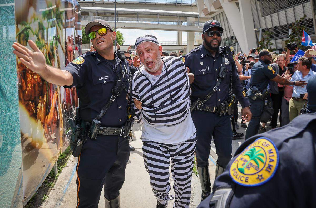 Domenic Santana is arrested after obstructing the Donald Trump’s motorcade after the former president left the Wilkie D. Ferguson Jr. U.S. Courthouse on Tuesday, June 13, 2023, in downtown Miami, Fla. Former President Donald Trump plead innocent to the total of 37 counts in a federal indictment related to his handling of classified documents after he left office. He is the first former president to face federal charges and is expected to arrive at Wilkie D. Ferguson, Jr. U.S. Courthouse on Tuesday, June 13, 2023. Note: The police was keeping people at bay away from Domenic Santana,