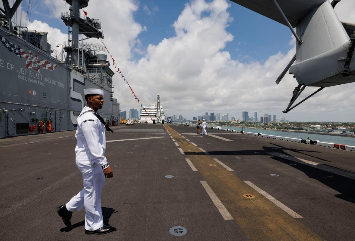 Erick Washington, religious program specialist, walks across the flight deck of the USS Bataan (LHD-5) during the opening day of Fleet Week on Monday, May 6, 2024, at Norwegian Cruise Lines Terminal in PortMiami.