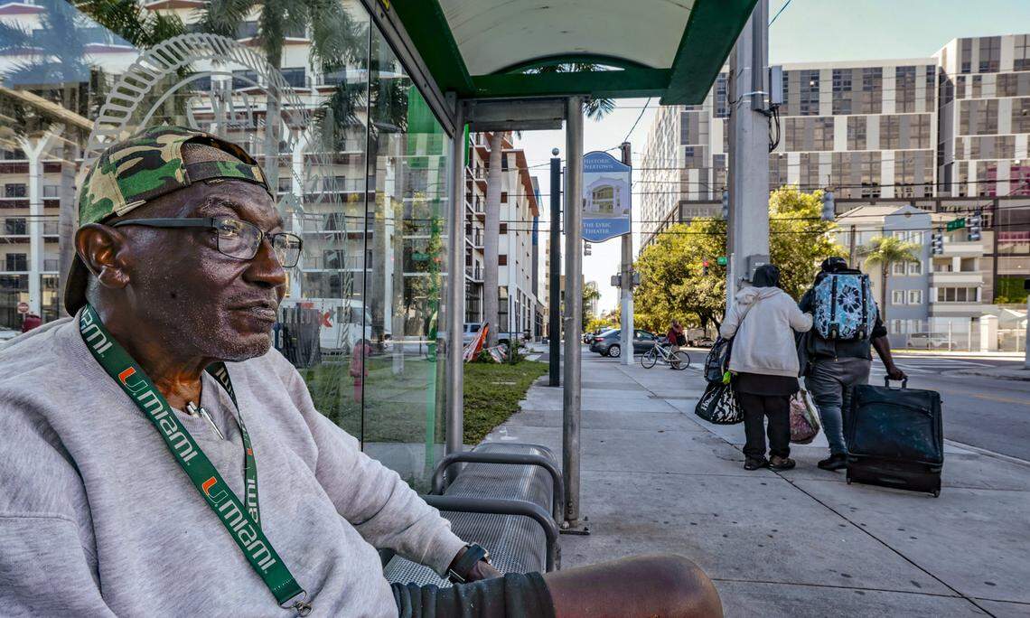 Tyrone Doberson, 78, a retired dock worker at the Port of Miami sits at a bus bench next to the Lyric Theater and across the street from the International Longshoreman's Association Local 1416 Union Hall in the heart of historic Overtown area. New residential towers are seen looking south along N.W. 2nd Avenue in Miami, FL, on Wednesday, October 15, 2025.