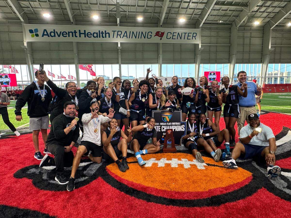 The Miami Palmetto flag football team celebrates after winning its first ever state championship following a thrilling 26-25 win over Lennard.
