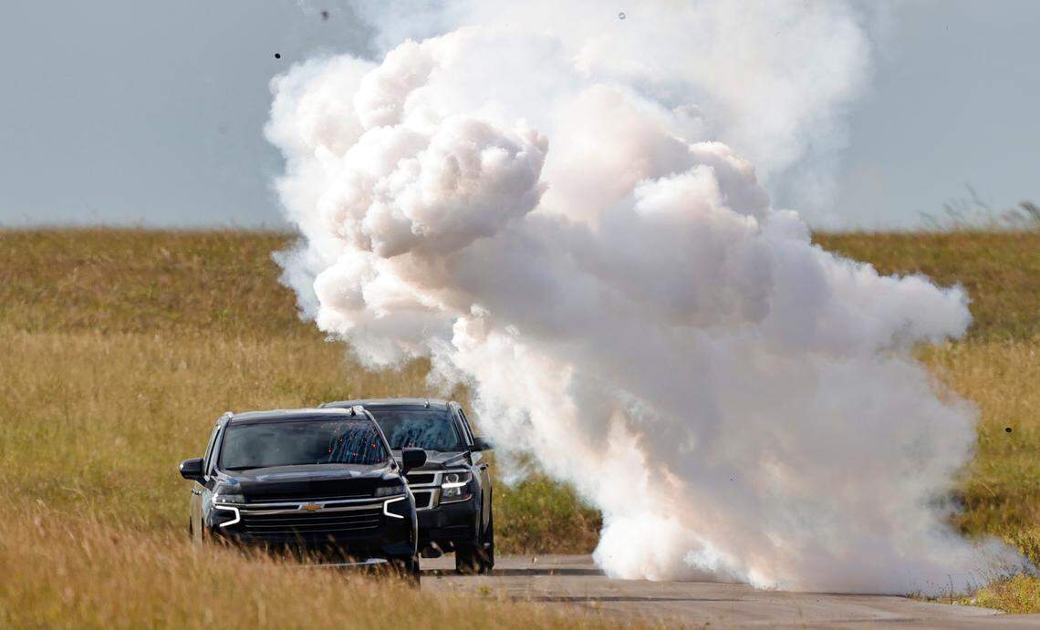 A caravan of cars passes near an explosion as the Diplomatic Security Service Miami Field Office is providing dignitary protection training to law enforcement partners from the Miami-Dade Police Department, the City of Miami Police Department, and the Broward County Sheriff’s Office at Miami-Dade Public Safety Training Institute on Wednesday, Nov. 10, 2021, in Doral, Florida.