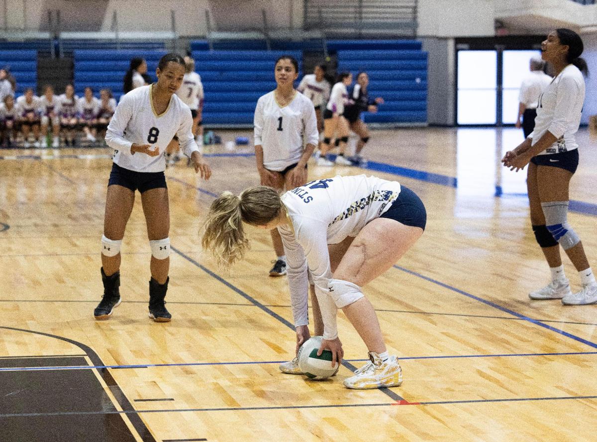 Deven Gonzalez, senior volleyball player for Miami High, who suffered injuries to her left leg in the Surfside collapse, reaches down to grab a ball during a match on Tuesday, Oct. 4, 2022, at Miami Dade College campus in Kendall. Gonzalez’s scar on her left leg can be seen, but her playing she says is almost back to normal. She lost her father in the collapse as well. “[Playing volleyball] was just another loss that I was not going to allow her to experience, not right now anyway,” said her mother, Angela.