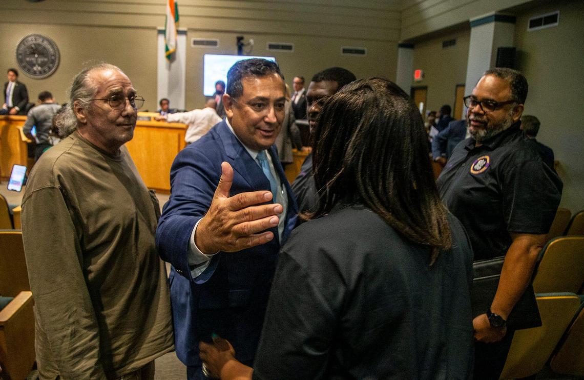 Embattled Miami Police Chief Art Acevedo reaches out to a small group of supporters, including members of the Miami Community Police Benevolent Association, at Miami City Hall after commissioners voted to fire him on Thursday, Oct. 14, 2021.