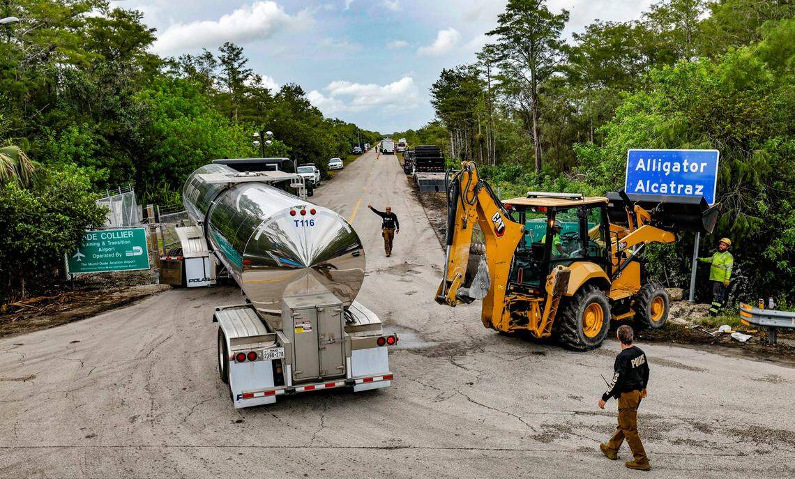 State police direct traffic as workers install a permanent Alligator Alcatraz sign. The facility is within the Florida Everglades, 36 miles west of the central business district of Miami, in Collier County, Florida. , Florida, on Thursday, July 3, 2025.