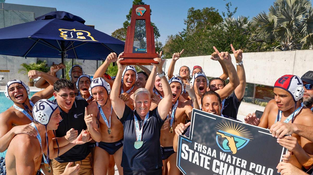 Gulliver Prep boys water polo head coach Carroll Vaughan holds up the Florida High School Water Polo State Championship trophy after the team defeats Dr. Phillips High School at Belen Jesuit Preparatory School in Miami, Florida on Saturday, April 20, 2024.