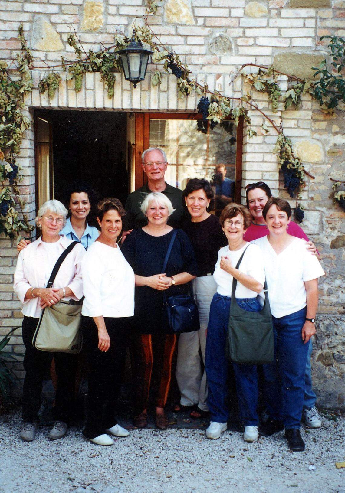 In this September 2000 file photo provided by Susan Brustman for a feature story she wrote, the Miami PR namesake of her firm Susan Brustman & Associates, later Brustman Carrino, is seen second from the left with a group on the “Cooking with Maria” tour at La Malvarina, a farm in the Umbrian region of Italy. She was in a group of nine American tourists on a seven-day culinary tour called Cooking with Maria. Maria was Maria Maurillo, a regional home cook featured in Bon Appetit magazine in her 70s.
