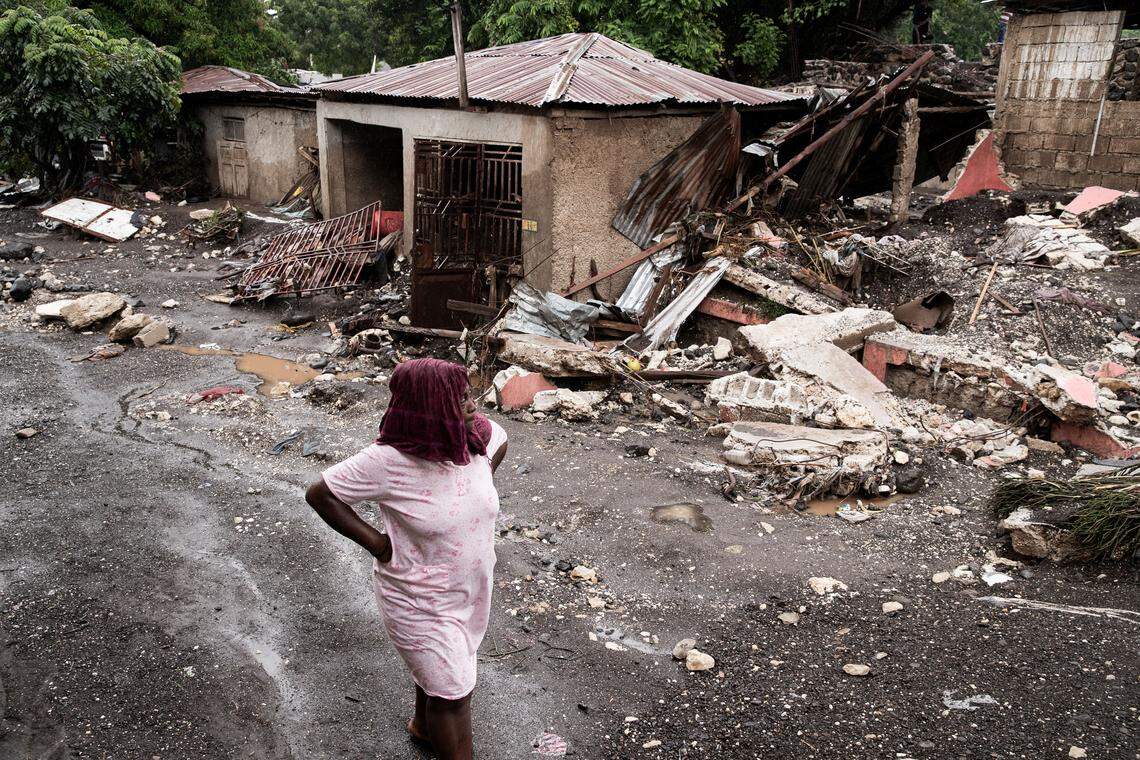 A woman walks past her house that was destroyed by Hurricane Melissa in Petit-Goave, 68km southwest of Port-au-Prince, on October 30, 2025. 