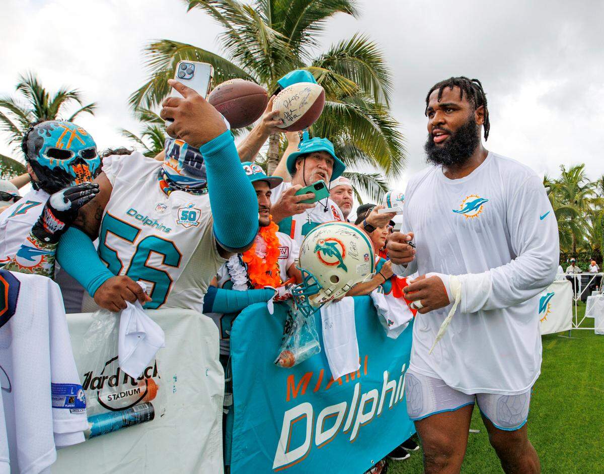 Miami Dolphins defensive tackle Christian Wilkins (94) interacts with fans after NFL football training camp at Baptist Health Training Complex in Hard Rock Stadium on Sunday, August 7, 2022 in Miami Gardens, Florida.