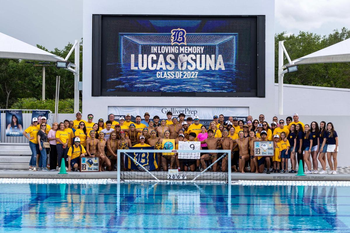 Miami, Florida, April 8, 2025 - Members of Belen’s Water Polo Team along with supporters pose for a group picture in front of a sign honoring Lucas Osuna after a match against Coral Gables High at Gulliver Prep.