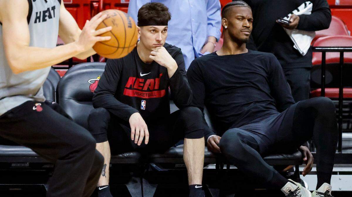 Miami Heat guard Tyler Herro (14) and Miami Heat forward Jimmy Butler (22) watch the end of practice from the bench during the NBA Finals media day on Tuesday at Kaseya Center on Tuesday, June 6, 2023.