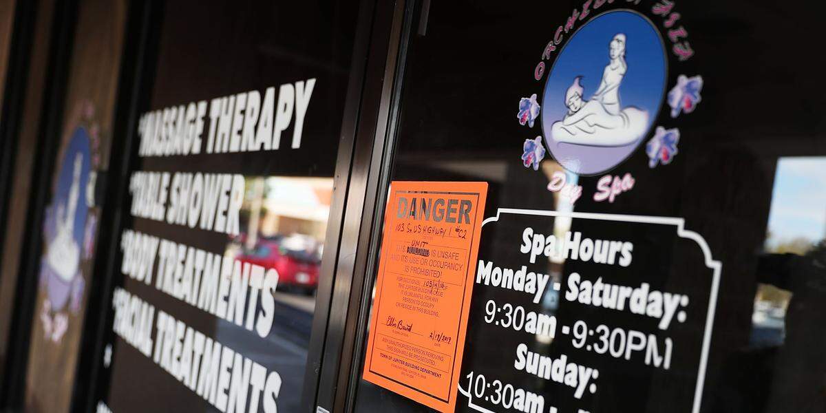 A ‘danger’ sign is posted on the front door of the Orchids of Asia Day Spa in Jupiter, Florida, prohibiting occupancy, in the wake of the investigation and filing of charges.
