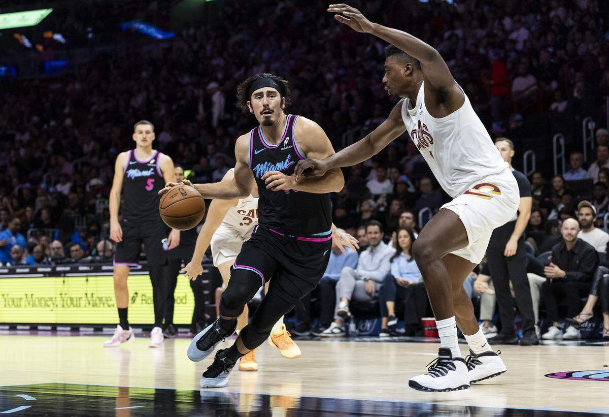Miami Heat forward Jaime Jaquez Jr. (11) drives the ball as Cleveland Cavaliers center Thomas Bryant (3) defends in the second half of their NBA game at Kaseya Center on Nov. 12, 2025, in Miami.
