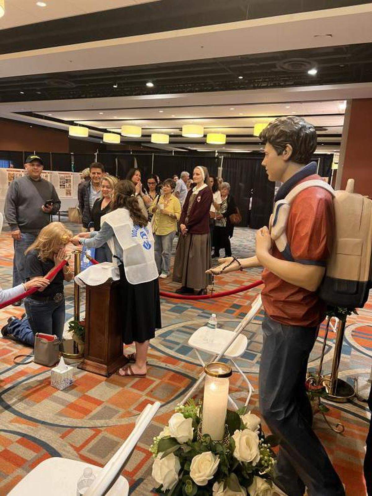 People line up to pray to a relic of Carlo Acutis during an exhibit organized by the Servants of the Pierced Hearts of Jesus and Mary in 2022. Acutis is set to become the first millennial saint in the Catholic Church.