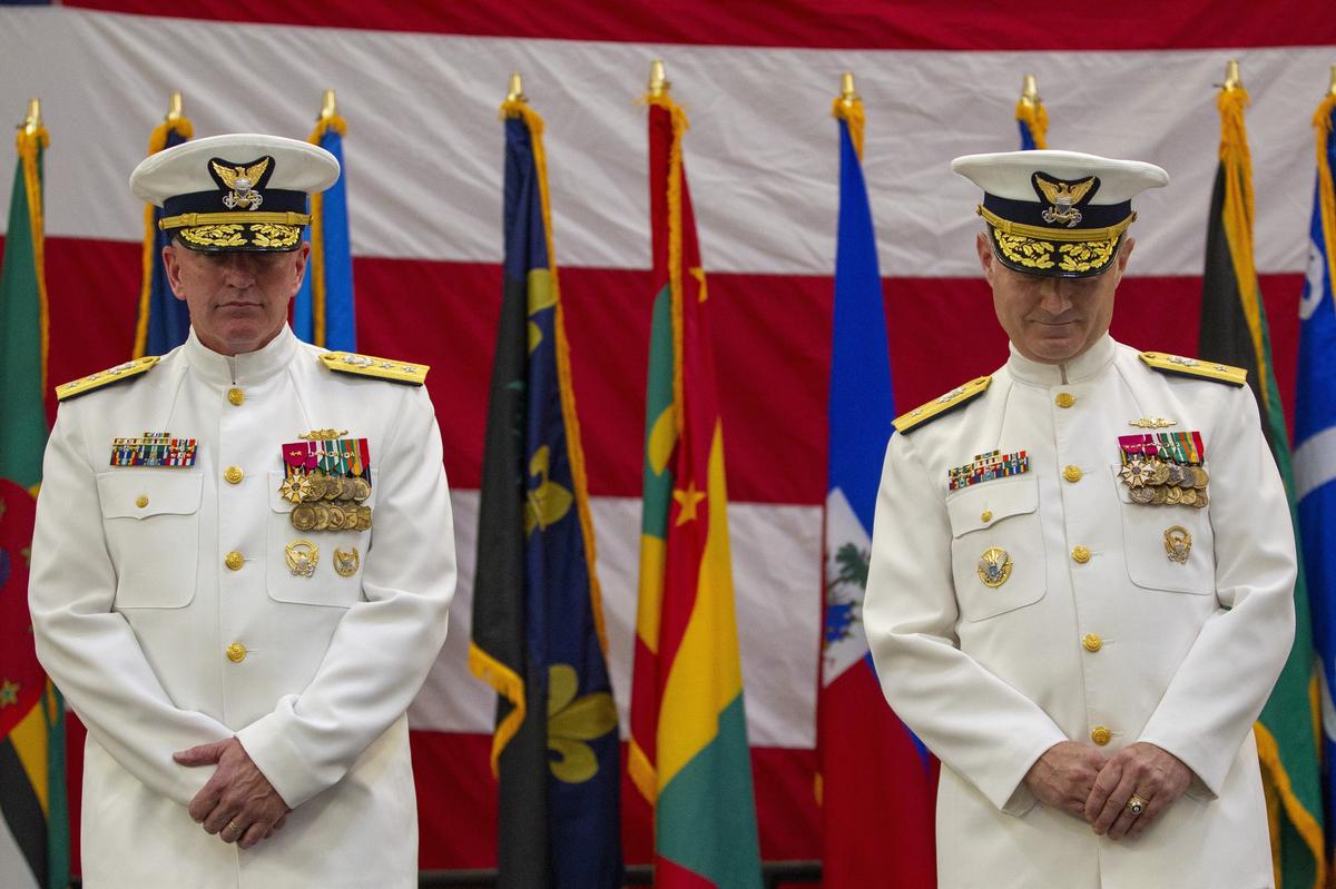 New Commander of the Coast Guard Seventh District, Rear Adm. Eric C. Jones, right, and U.S. Coast Guard Rear Adm. Peter J. Brown bow their head in prayer at Coast Guard Air Station Miami in Opa-locka on Wednesday, June 19, 2019.