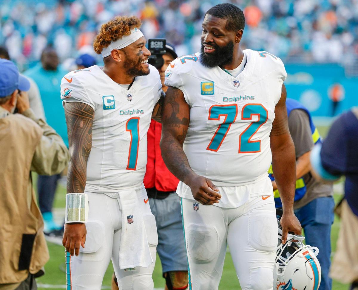 Miami Dolphins quarterback Tua Tagovailoa (1) and Miami Dolphins offensive tackle Terron Armstead (72) walk off the field after defeating the New York Jets in their NFL football game at the Hard Rock Stadium in Miami Gardens, Florida on Sunday, December 8, 2024.