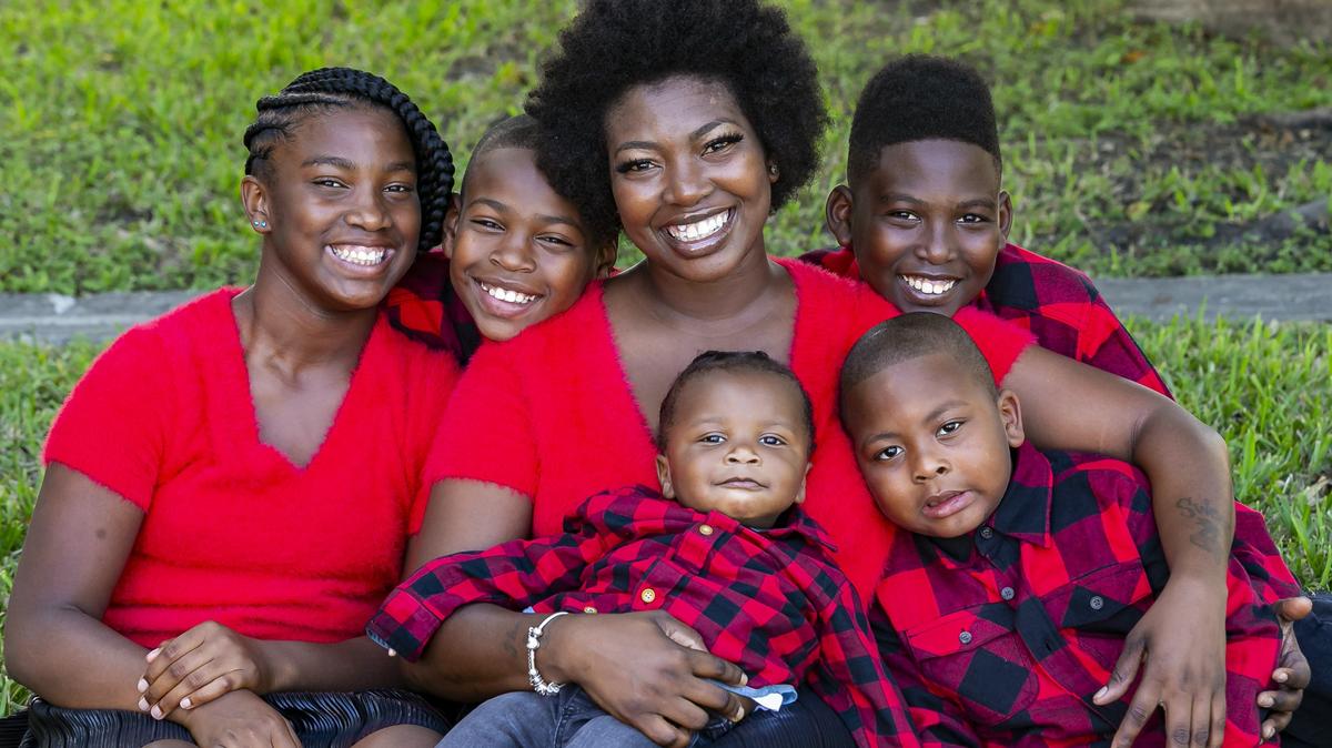 From the left: Christyana Richardson, 10, Terrence Simpson, 11, Sherina Akins, 33, Tharon Simpson, 12, Isaiah Shine, 11 months-old and Bronchea King, 5, near their home in North Miami.