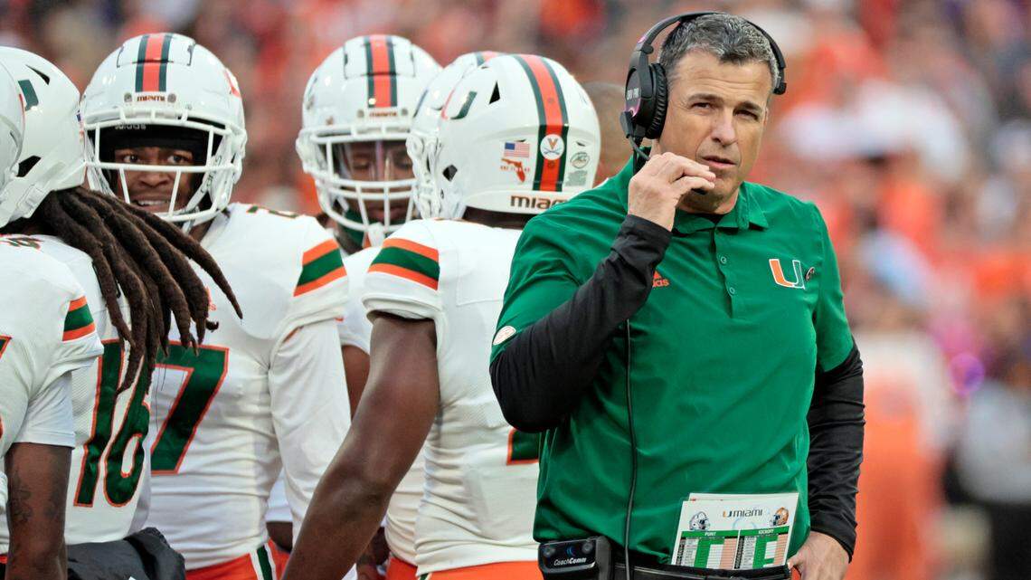 Miami Hurricanes head coach Mario Cristobal on the field during a timeout in the first half against the Clemson Tigers at Frank Howard Field at Clemson Memorial Stadium in Clemson, South Carolina on Saturday, November 19, 2022.