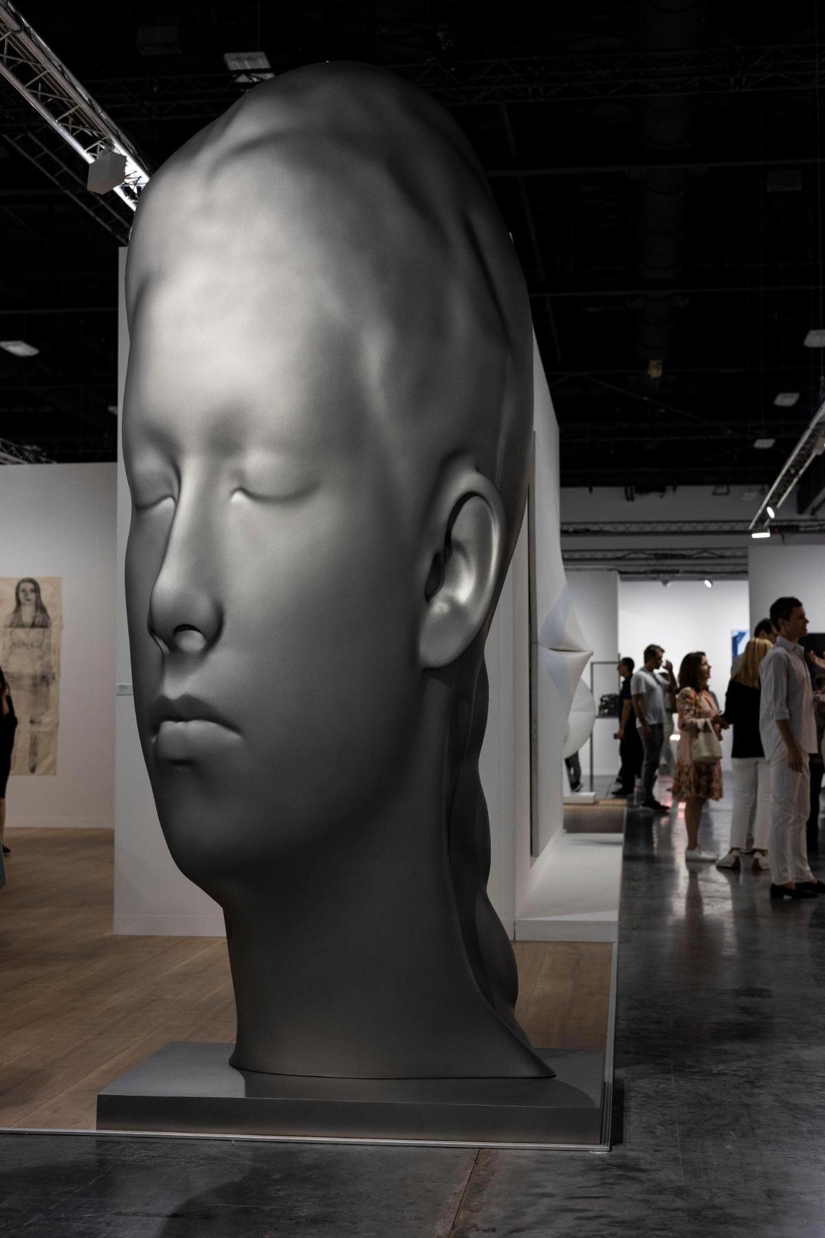 Miami Beach, FL- November 29, 2022 -A stainless steel sculpture titled Lara, 2020 by Jaume Plensa at the Art Basel VIP opening day at the Miami Beach Convention Center.