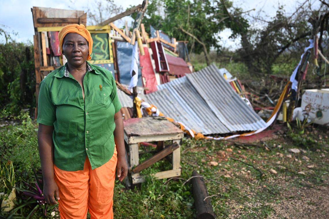 Celia Coke stands next to her shop, destroyed after the passage of Hurricane Melissa in the Wilton district of St. Elizabeth, Jamaica on October 29, 2025. Hurricane Melissa ripped up trees and knocked out power after making landfall in Jamaica on October 28, 2025 as one of the most powerful hurricanes on record, inundating the island nation with rains that threaten flash floods and landslides.