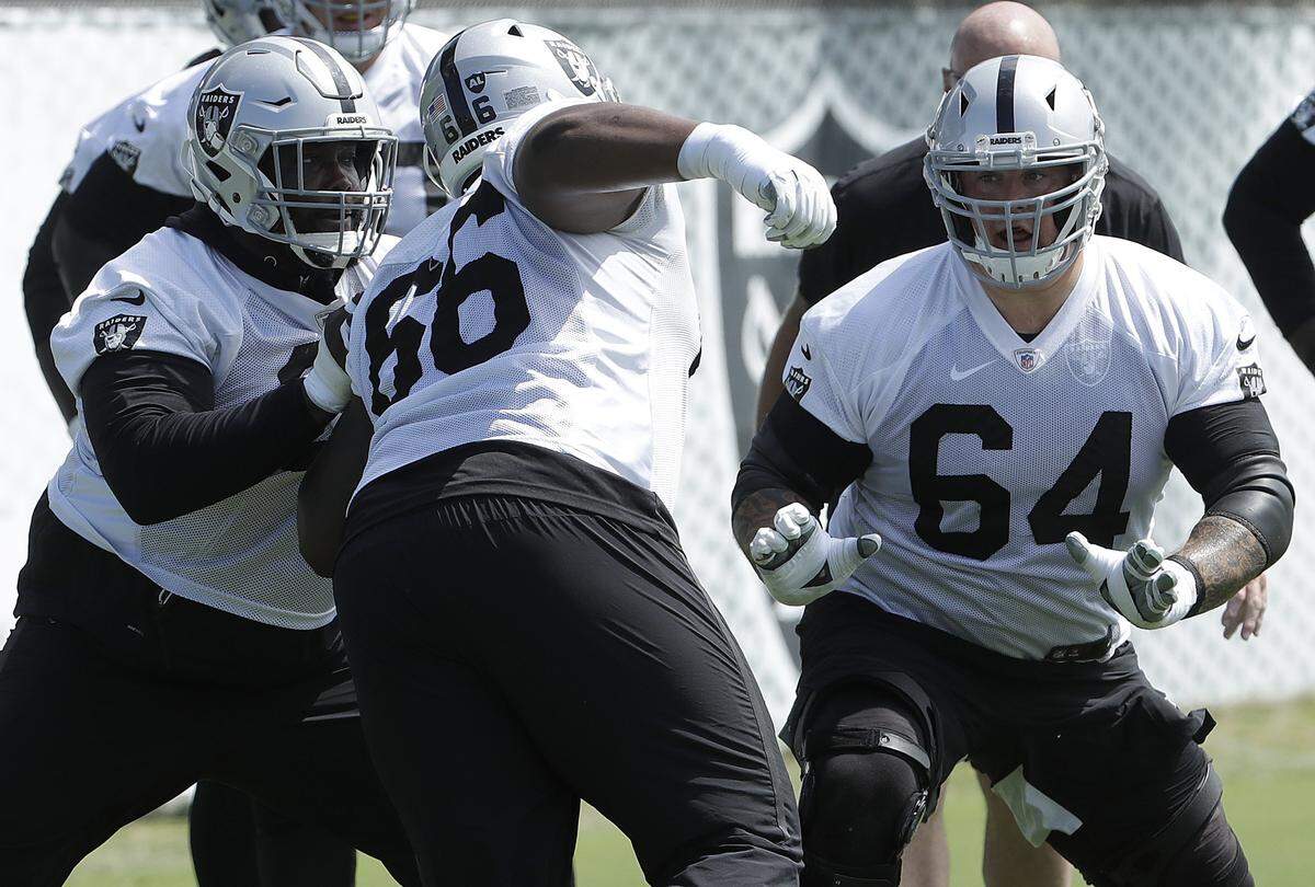 Oakland Raiders center Rodney Hudson, left, and guard Richie Incognito, right, block Gabe Jackson during an official team activity at the NFL football team’s headquarters in Alameda, Calif., Tuesday, May 28, 2019. (AP Photo/Jeff Chiu)