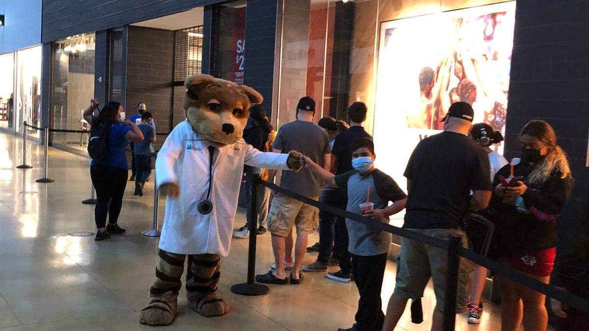 Molina Healthcare of Florida and Young Dreams Community Outreach representatives came together to host their second annual Nike shoe giveaway to help Miami-Dade County students in need. Dr. Cleo, Molina Healthcare’s mascot, greets families as they wait in line at the Nike store in Dolphin Mall.
