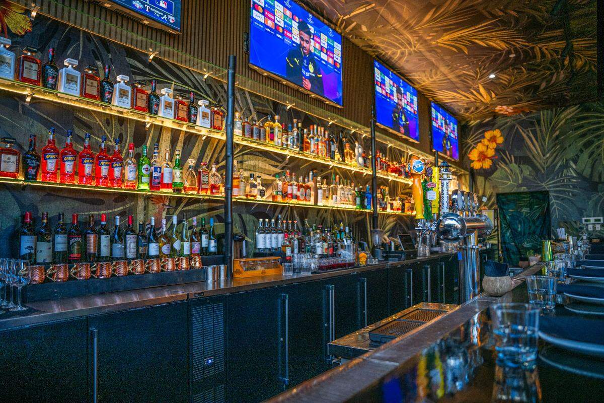 The 12 seat bar at Canvas has flat screen TVs