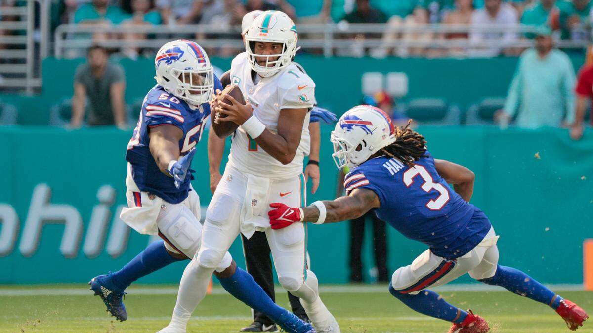 Miami Dolphins quarterback Tua Tagovailoa (1) scrambles as he is chased by Buffalo Bills defenders in the second half at Hard Rock Stadium in Miami Gardens on Sunday, September 25, 2022.