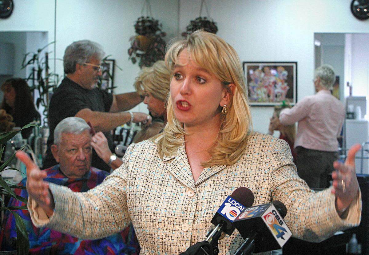 Tiffany Carr — shown during a 2004 visit to a Hollywood nail salon, where she spoke on domestic violence — announced Nov. 14, 2019, that she was stepping down as the CEO and president of the Florida Coalition Against Domestic Violence.