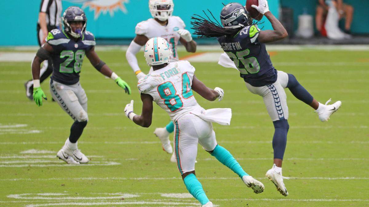 Seattle Seahawks cornerback Shaquill Griffin (26) intercepts the ball intended for Miami Dolphins wide receiver Isaiah Ford (84) in the fourth quarter at Hard Rock Stadium in Miami Gardens on Sunday, October 4, 2020.