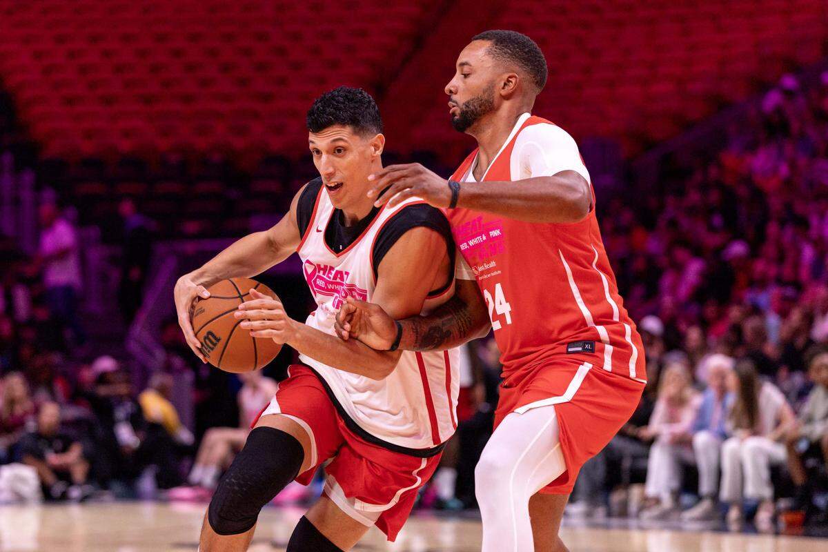 Miami Heat forward Simone Fontecchio drives on guard Norman Powell during the annual Red, White and Pink intrasquad Heat scrimmage at Kaseya Center on Wednesday, October 15, 2025, in Miami, Fla.