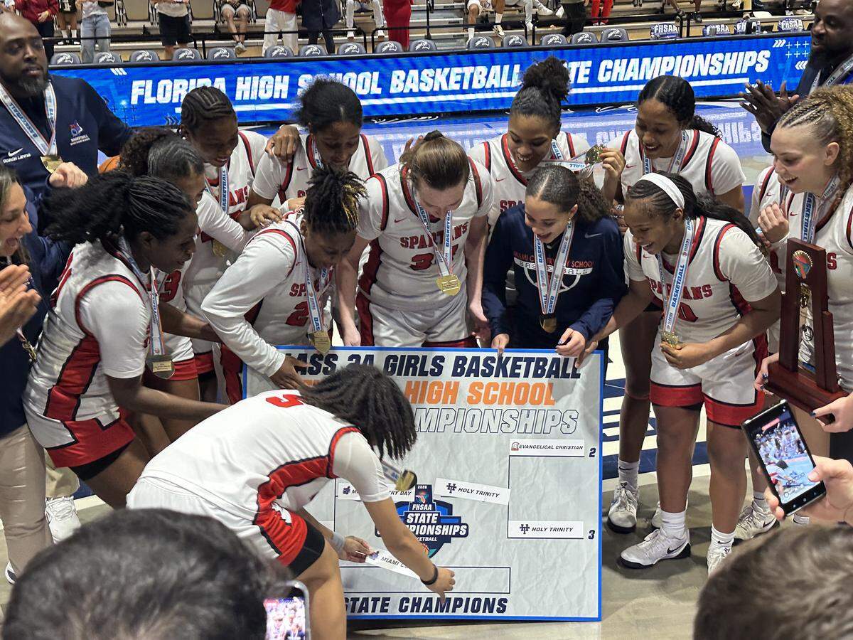 Miami Country Day’s Kamie Ellis places her team’s name on the Class 2A state championship bracket following the Spartans’ 49-44 victory over Melbourne Holy Trinity on Saturday at UNF Arena in Jacksonville, Fla.