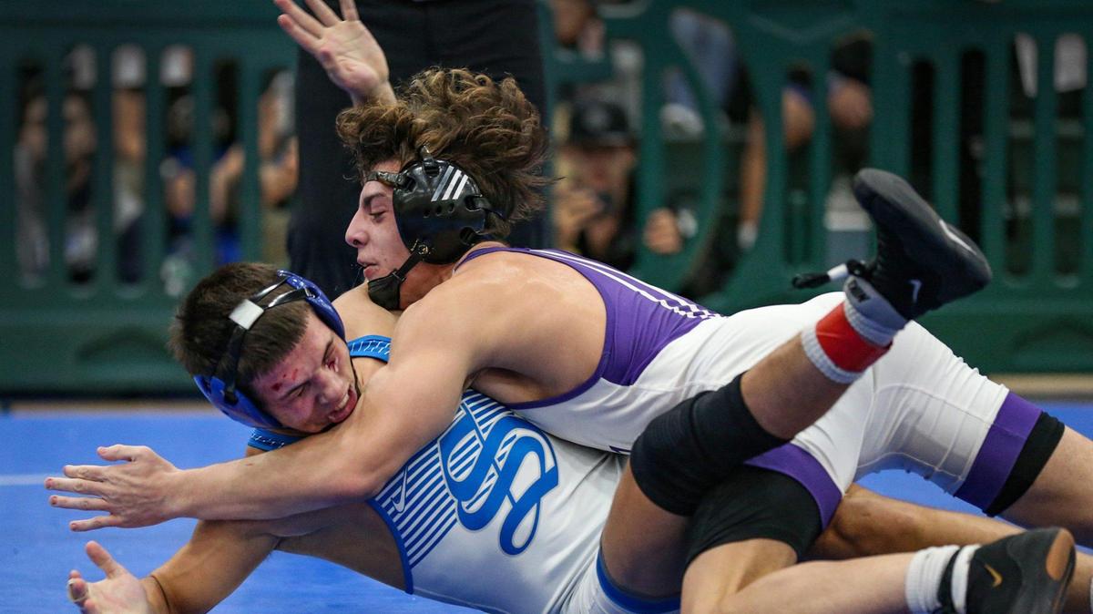 Alex Couto, at left, of South Dade High School battles against Adrian Ochoa, at the right, of Southwest High School during the GMAC Boys Wrestling Championship held at Ronald Reagan High School on Saturday, February 5, 2022.