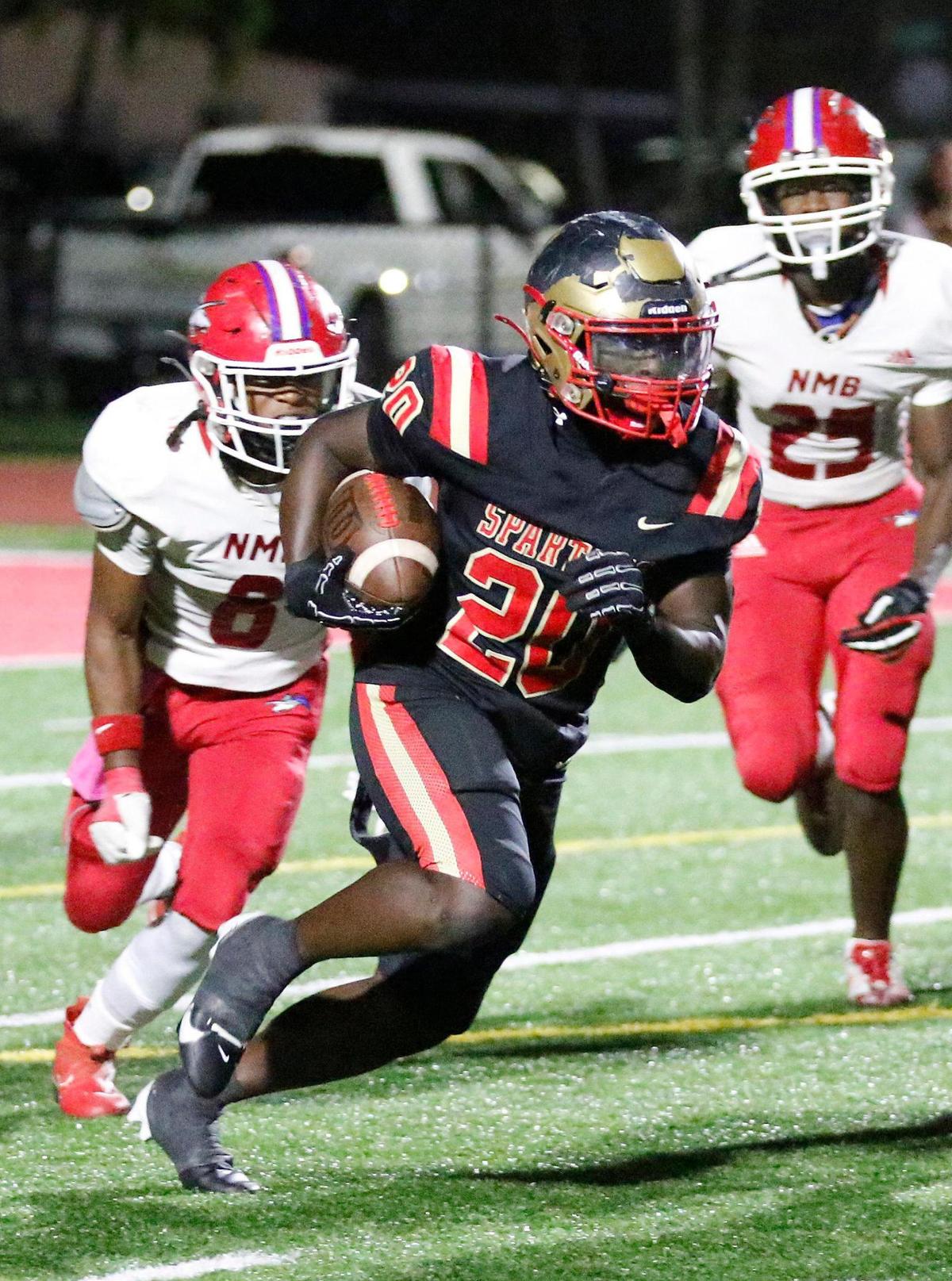 Monsignor Pace Spartans running back Rashad Wallace Jr. (20) carries the ball against North Miami Beach Charges during football game on Friday, October 25, 2024 at Monsignor HS in Miami. Andrew Uloza / for Miami Herald