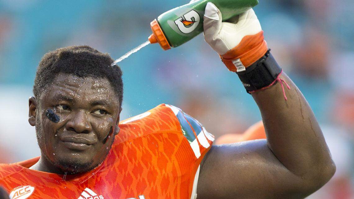 Miami Hurricanes offensive lineman Sunny Odogwu (66) cools off as the University of Miami hosts Florida A&M at Hard Rock Stadium on September 3, 2016.